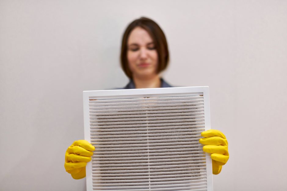 A woman cleaning mold on ac vents